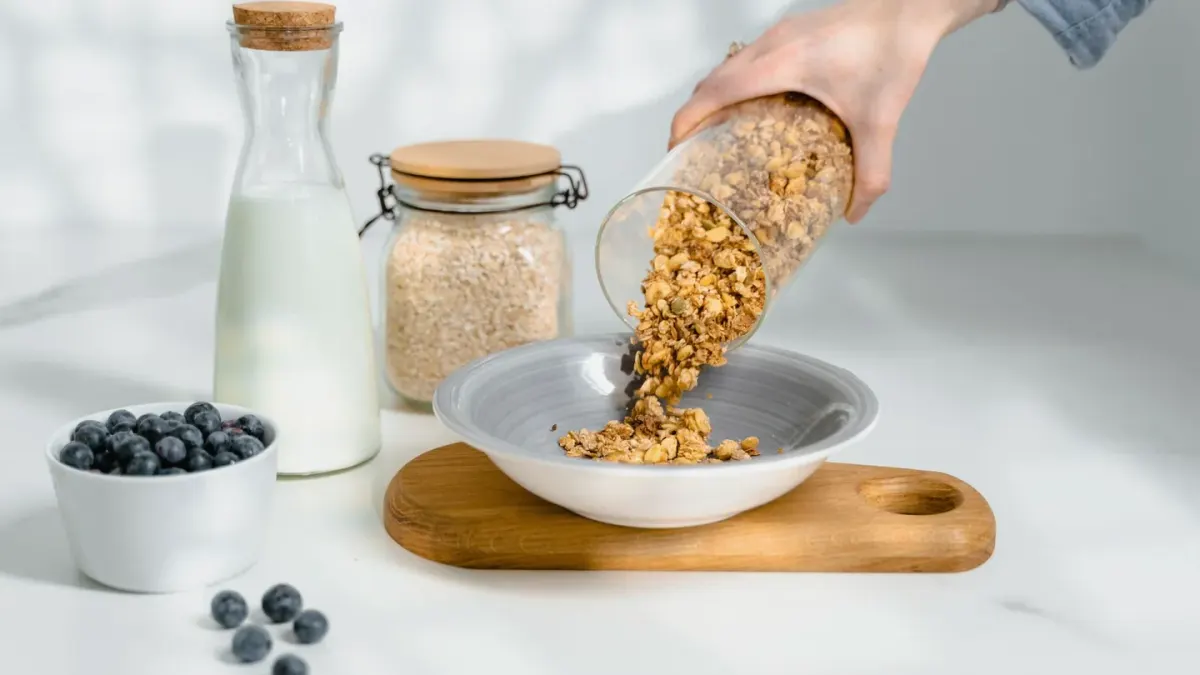 A supplement bottle sitting next to a bowl of dog food on a kitchen counter