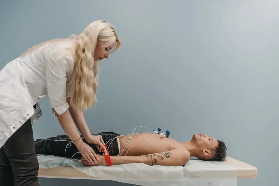 A veterinarian examining a young male dog during a wellness visit