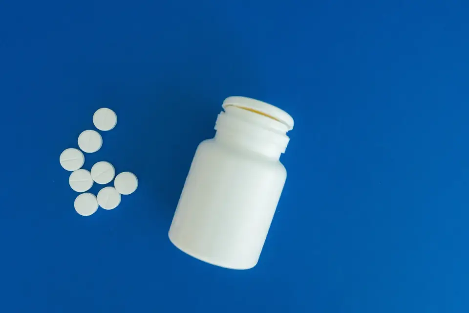 Calming chews and a supplement bottle sitting on a kitchen counter