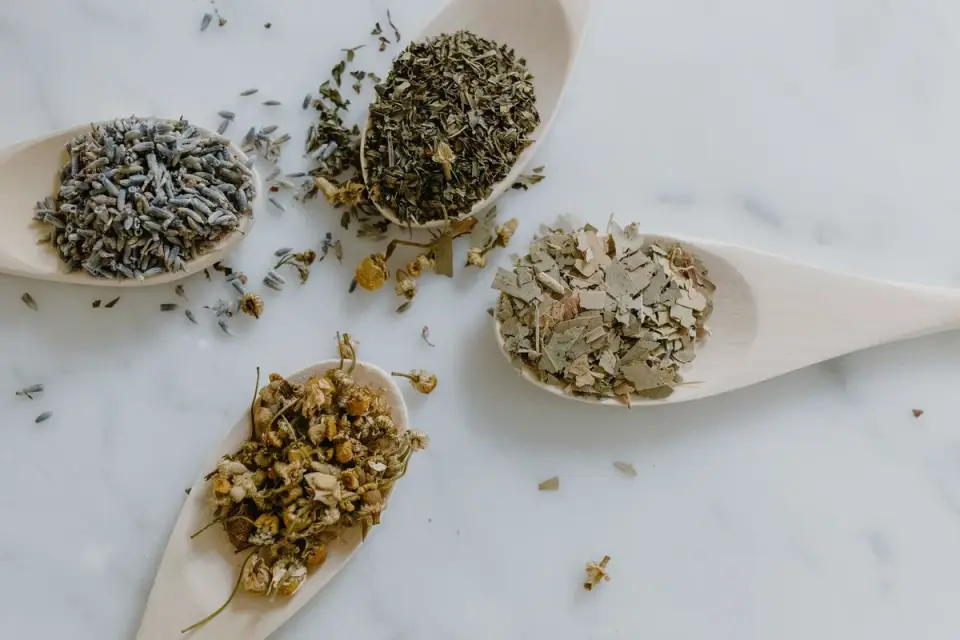 Dried chamomile flowers and herbal supplement ingredients laid out on a table