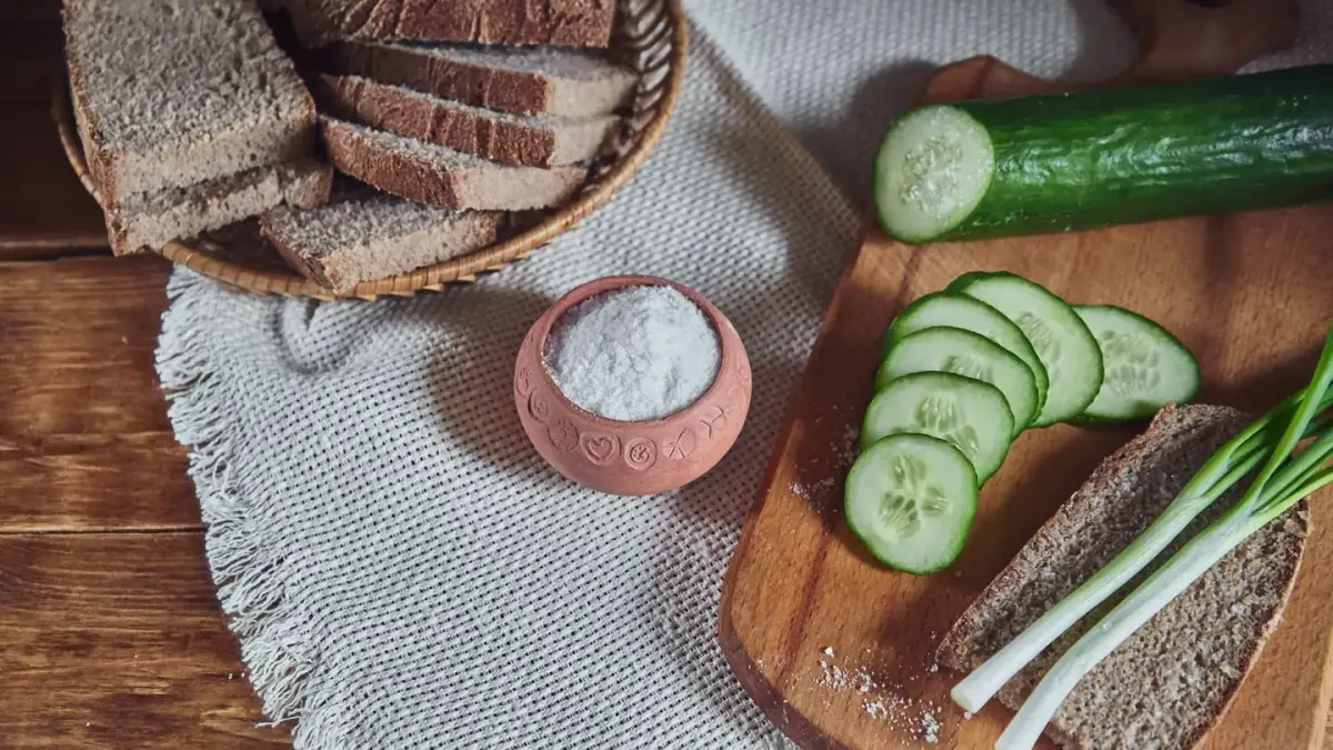Sliced onion on a wooden cutting board with a dog nearby in the kitchen